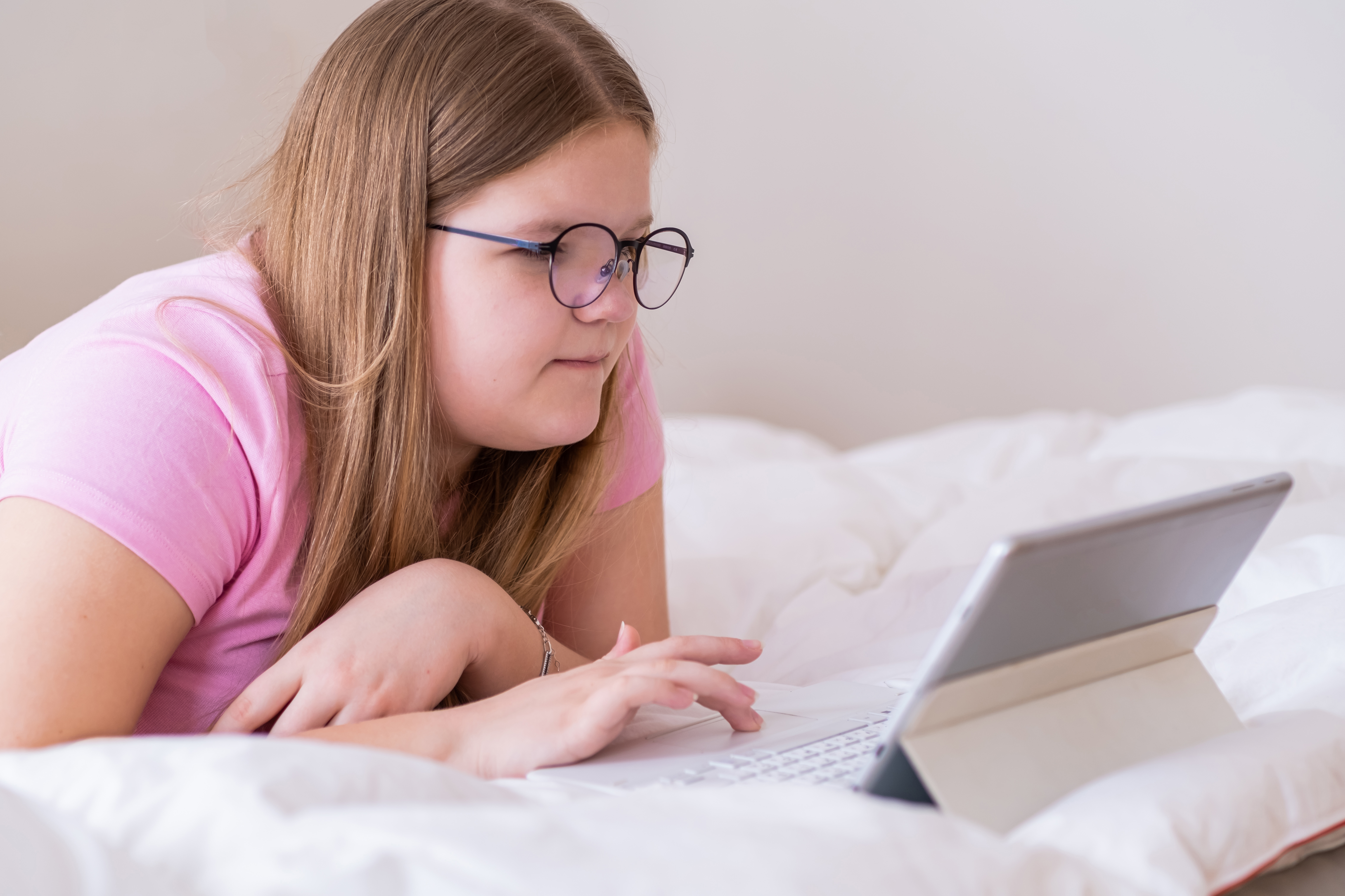A child using a tablet while relaxing at home